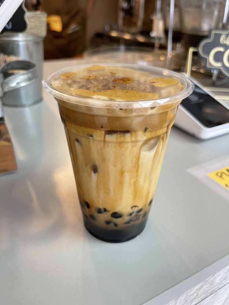 Iced coffee with boba pearls at the HoneyBoba counter